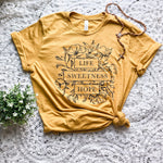 Mustard yellow t-shirt with floral design and text.