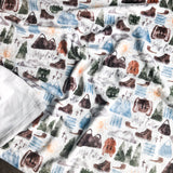 Blanket with mountain, backpack, and boot pattern.