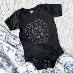 Black baby onesie with St. Benedict symbol,...