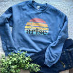 Blue Arise sweatshirt with jeans.